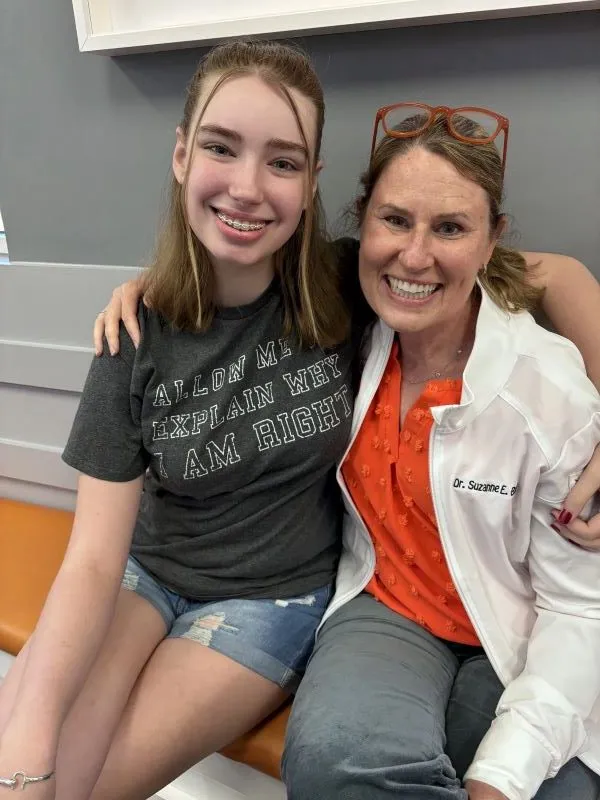 Dr. Bird and a girl with clear ceramic braces